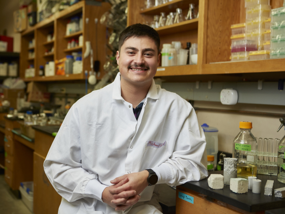 Photo of Michael Espinal in a lab coat